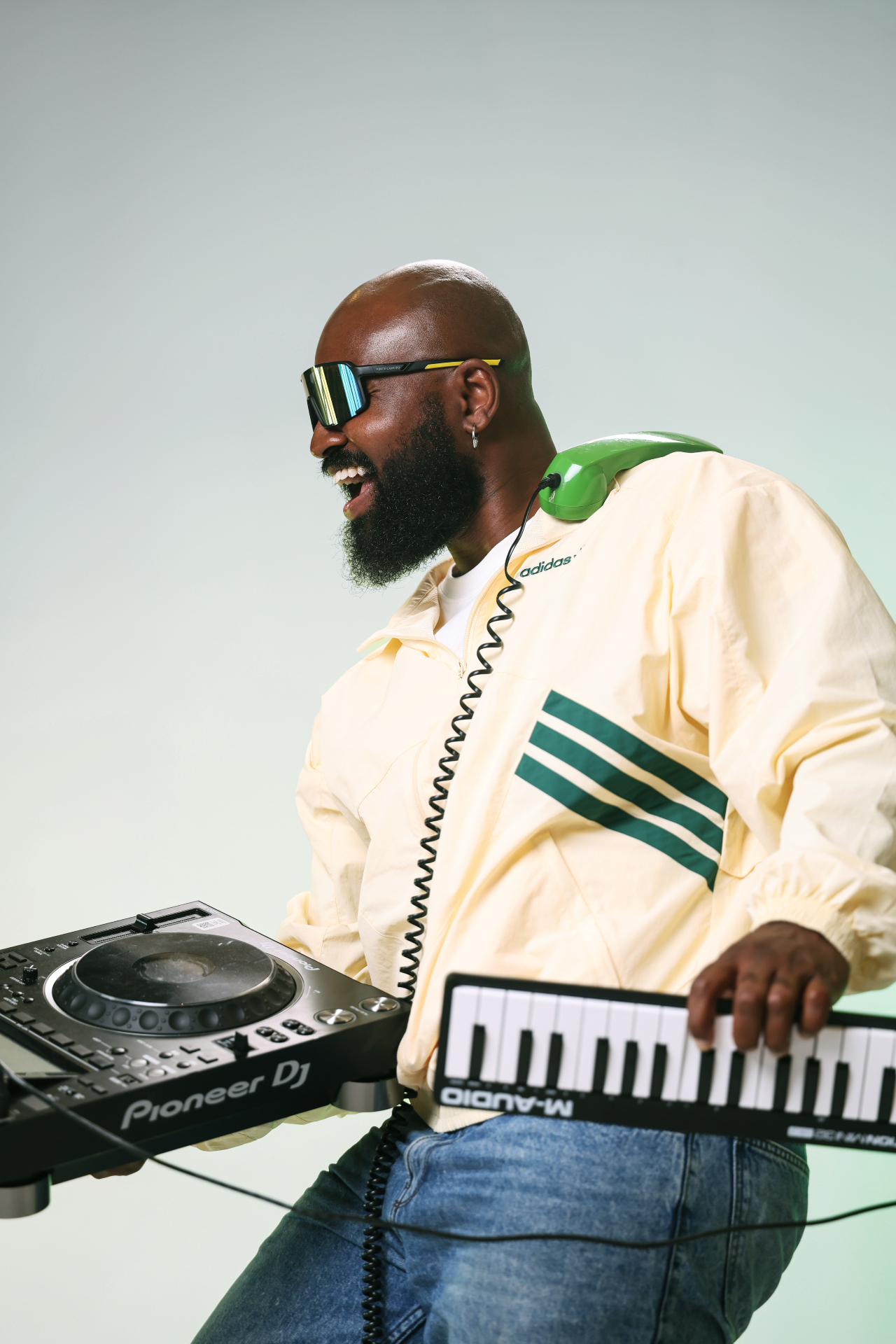 Audio Paak with DJ equipment, a keyboard and a green telephone. Photo: Alikoto Music Consult.
